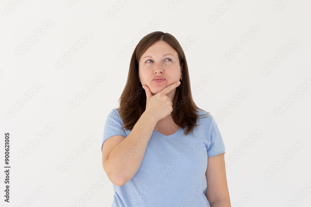 Closeup photo of amazing lady looking up empty space deep thinking creative person arm on chin wear casual blue t-shirt isolated white color background Closeup photo of amazing lady looking up empty space deep thinking creative person arm on chin wear casual blue t-shirt isolated white color background