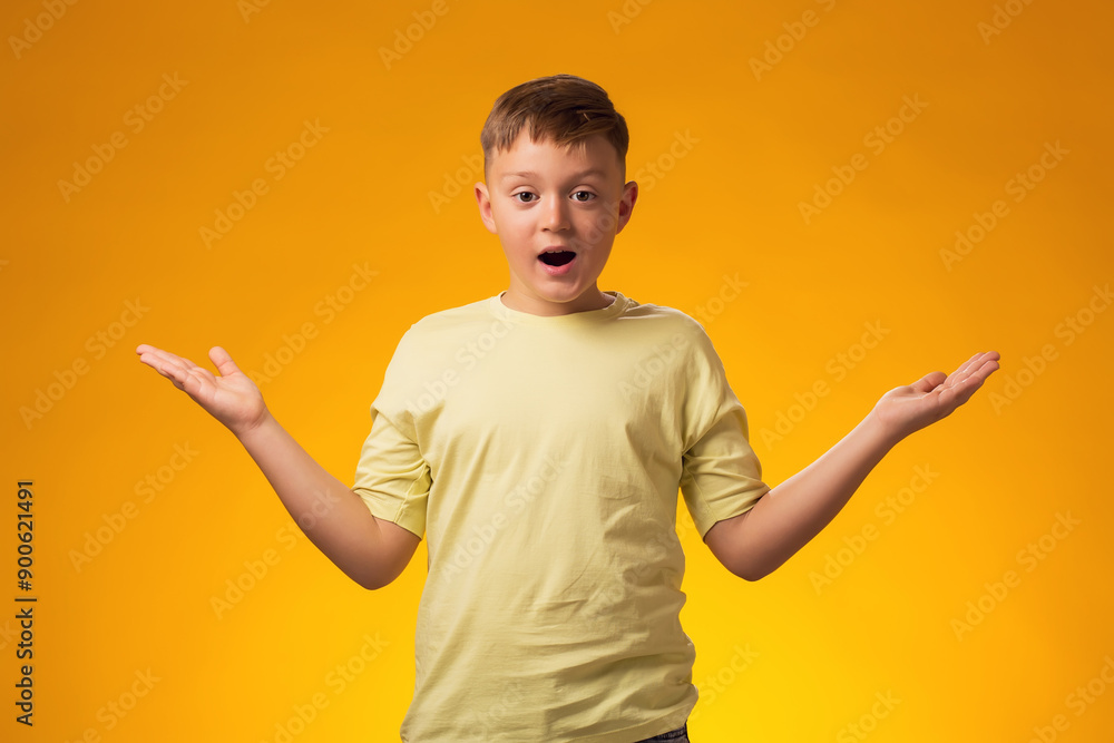 Surprised child boy with opened mouth on yellow background. Surprised child boy with opened mouth on yellow background.