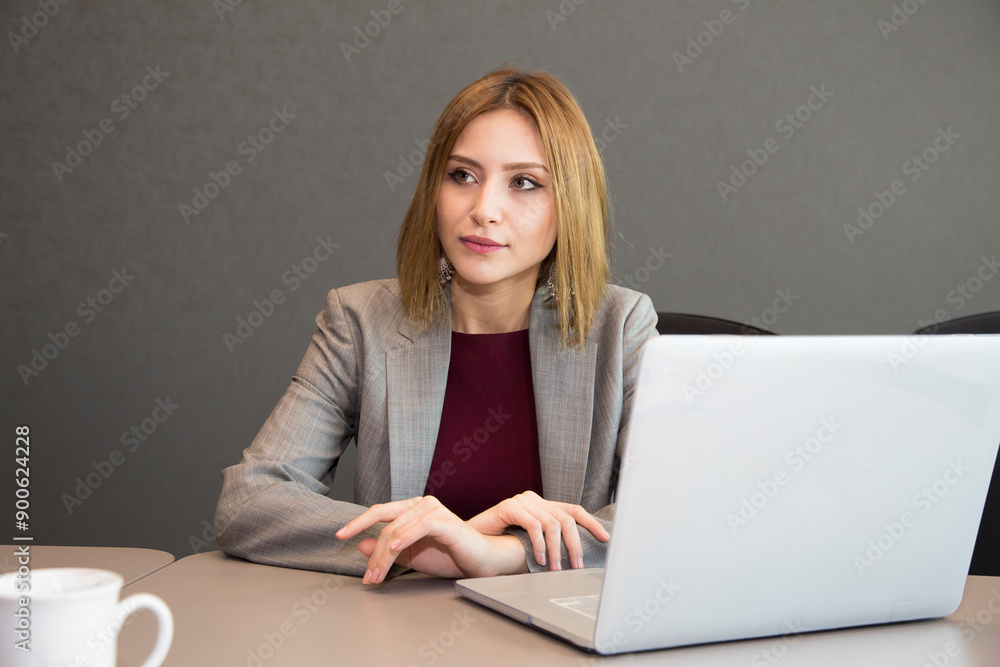 A businesswoman works in the office with a laptop A businesswoman works in the office with a laptop