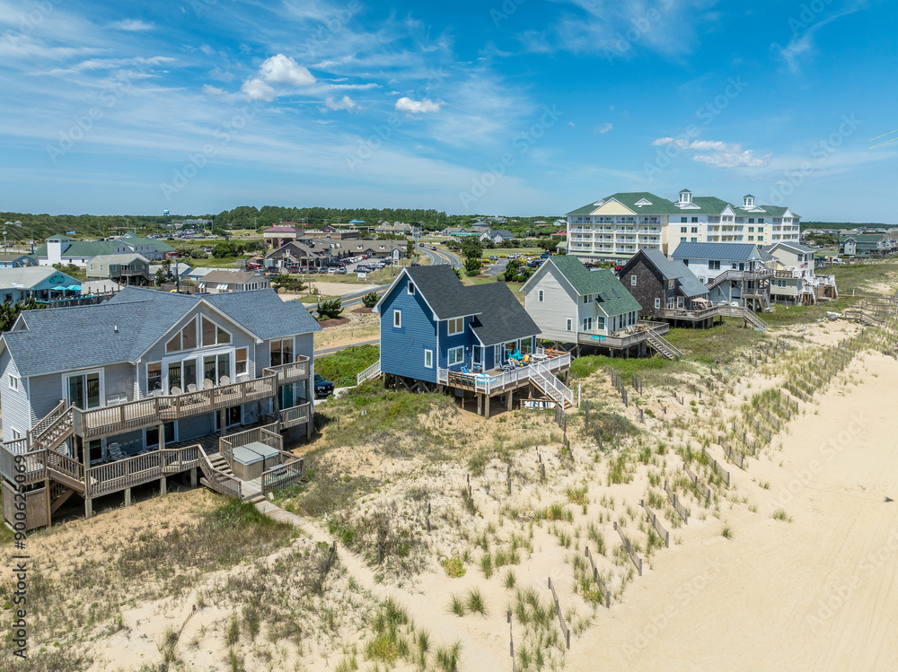 Obraz premium Aerial view of colorful beach front vacation rental properties in the outer banks with beach access, pool, patio, prime American vacation destination
