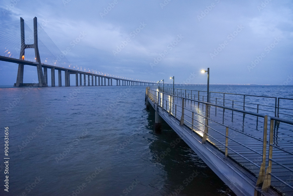 Fototapeta premium Rainy night image of the Vasco da Gama bridge from the Parque das Naçoes in Lisbon.