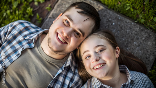 High angle portrait of young couple with Down Syndrome and Foetal Alcohol Syndrome next to each other and smiling © Танюша Коновал