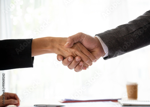 Close-up of handshake between two business professionals, symbolizing agreement, partnership, and successful negotiation photo