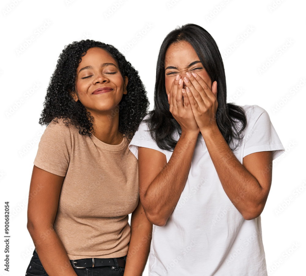 Young Latin friends in studio laughing about something, covering mouth with hands. Young Latin friends in studio laughing about something, covering mouth with hands.