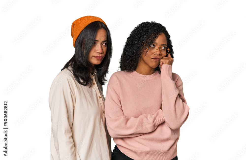 Young Latin friends together in studio who feels sad and pensive, looking at copy space. Young Latin friends together in studio who feels sad and pensive, looking at copy space.