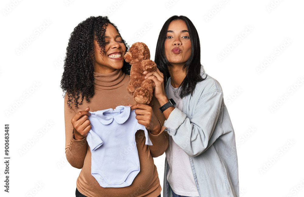 Two Latin women, one pregnant, with teddy bear in studio Two Latin women, one pregnant, with teddy bear in studio