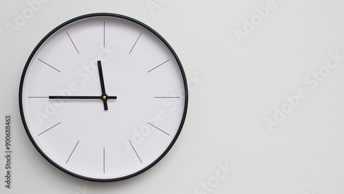 Wall Clock Showing 23.45/11.45 O'Clock on White Wooden Surface - Perfect for Time Management and Scheduling Concepts photo