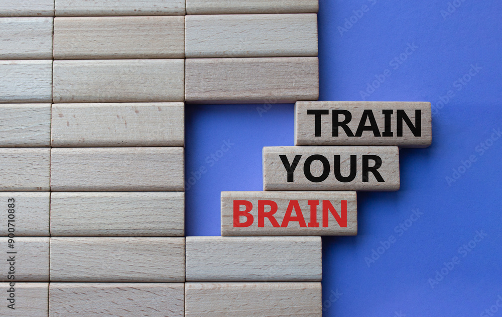 Train Your Brain symbol. Concept words Train Your Brain on wooden blocks. Beautiful purple background. Businessman hand. Business and Train Your Brain concept. Copy space. Train Your Brain symbol. Concept words Train Your Brain on wooden blocks. Beautiful purple background. Businessman hand. Business and Train Your Brain concept. Copy space.