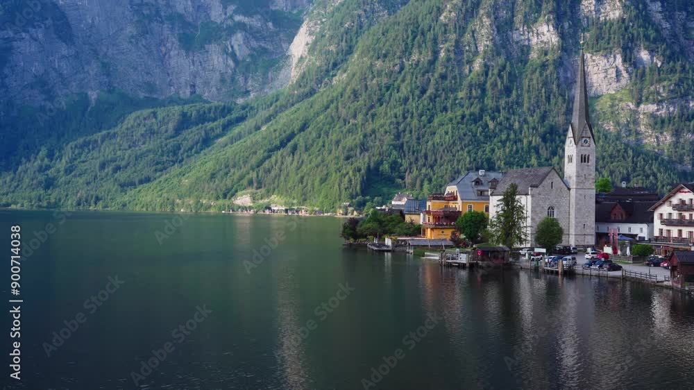 Picturesque village by lake with towering mountains Picturesque village by lake with towering mountains