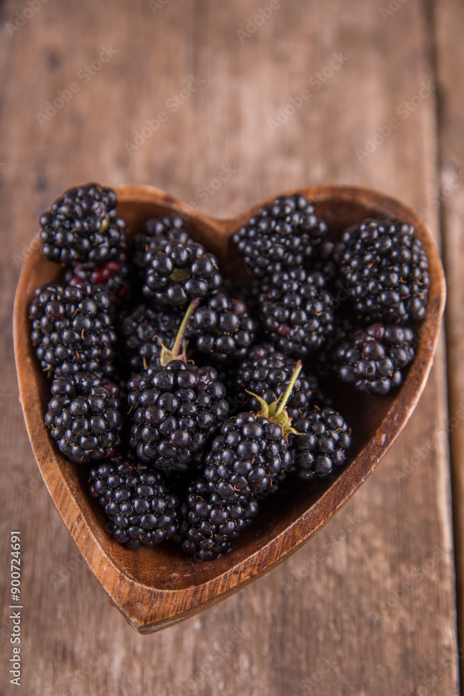 Ripe black blackberries on a wooden table Ripe black blackberries on a wooden table
