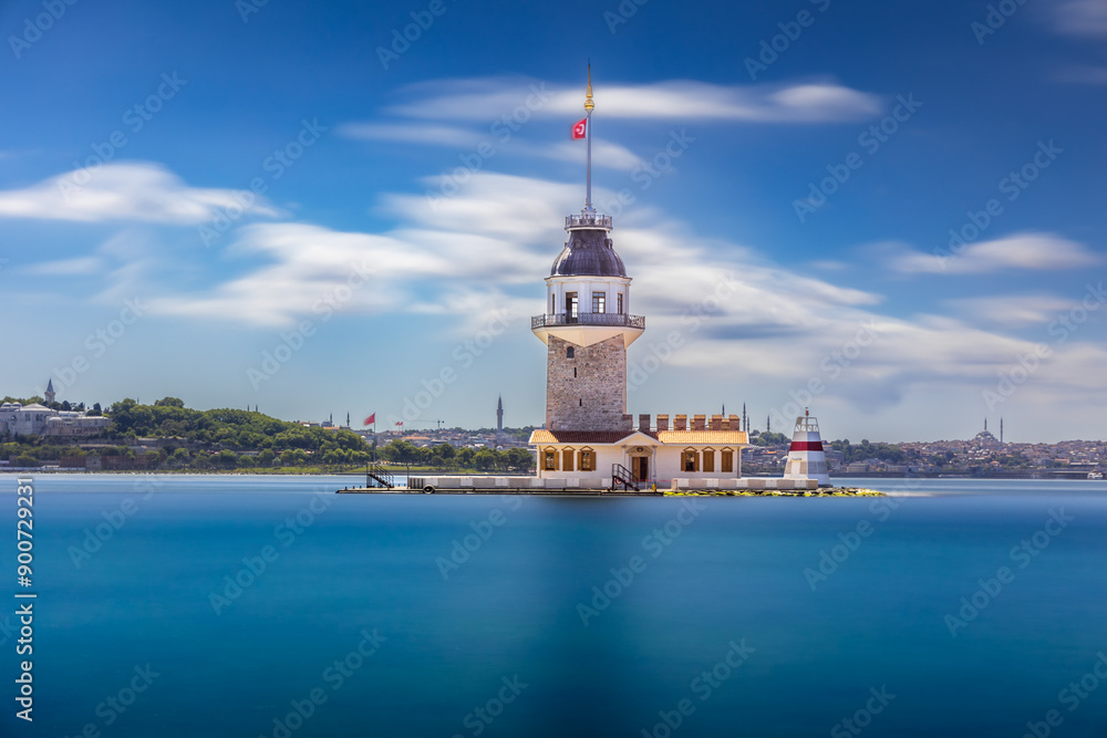 Fototapeta premium Tower like lighthouse on island in sea Postcard view Blurred clouds, smooth water, Istanbul, Turkey