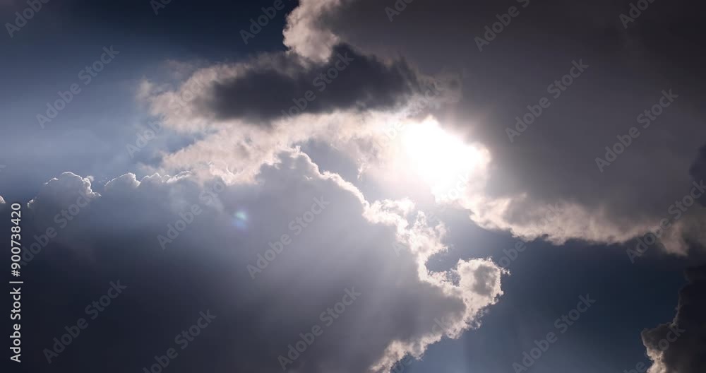 Contrasting sky with clouds and sun rays in motion Contrasting sky with clouds and sun rays in motion