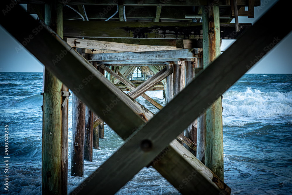 Underneath Wooden Pier with Ocean Waves Underneath Wooden Pier with Ocean Waves