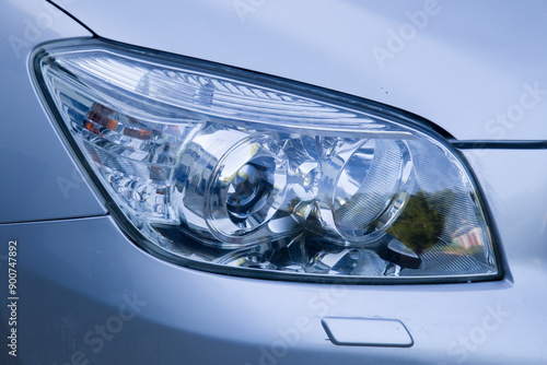 Polishing the old headlight on the car and installing a protective film.