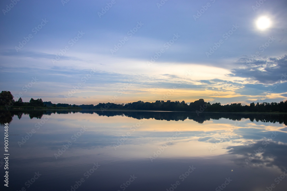 Fototapeta premium Calm and beautiful silent moment at the lake shore. Sunset during golden
