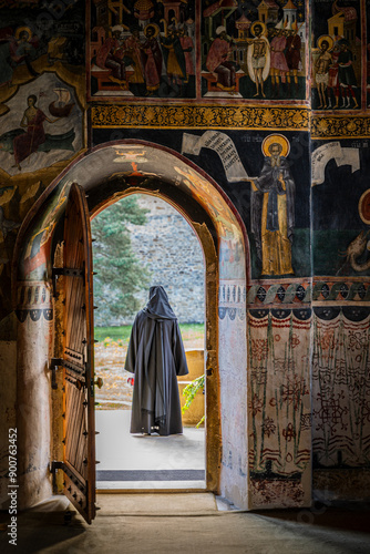 Solitude and Serenity: Monk at Monastery Entrance