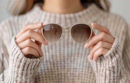 Woman Holding Sunglasses in Knit Sweater