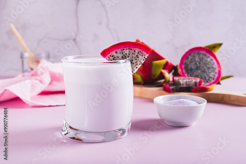 Trendy pink matcha dragon fruit latte in a glass on the table photo