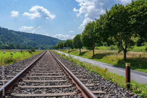 Landschaft mit Bahnschiene an einem Sommertag photo