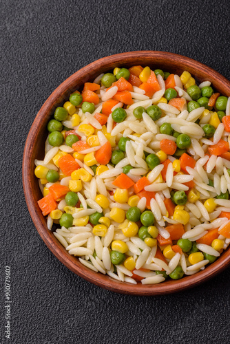 Delicious boiled rice with vegetables or risotto with carrots, peas and corn