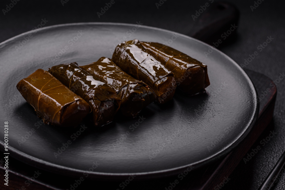 Delicious dolma in the form of rice and meat wrapped in grape leaves Delicious dolma in the form of rice and meat wrapped in grape leaves