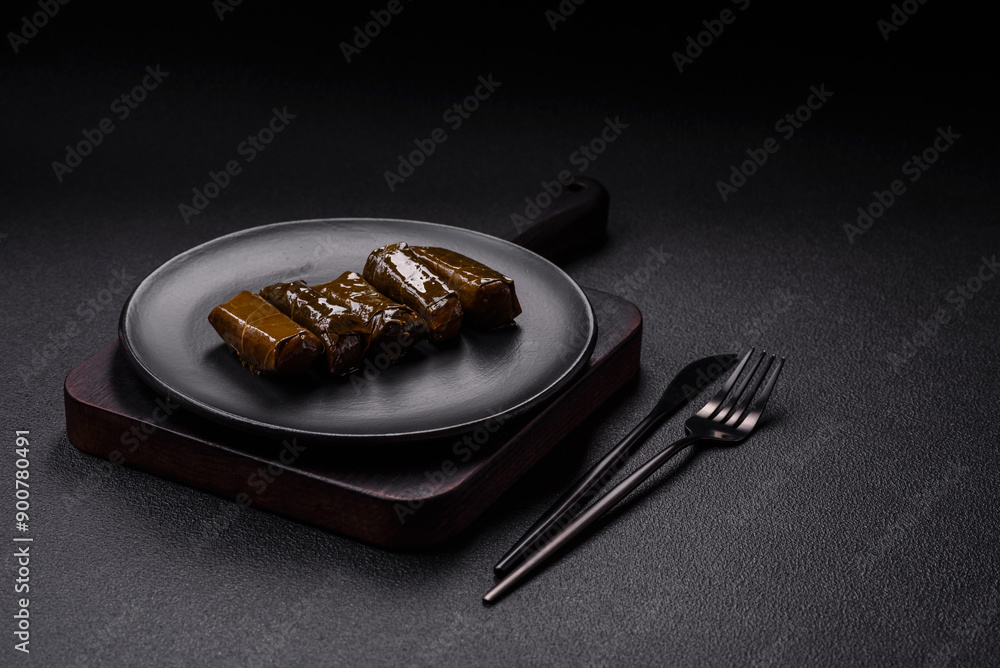 Delicious dolma in the form of rice and meat wrapped in grape leaves Delicious dolma in the form of rice and meat wrapped in grape leaves
