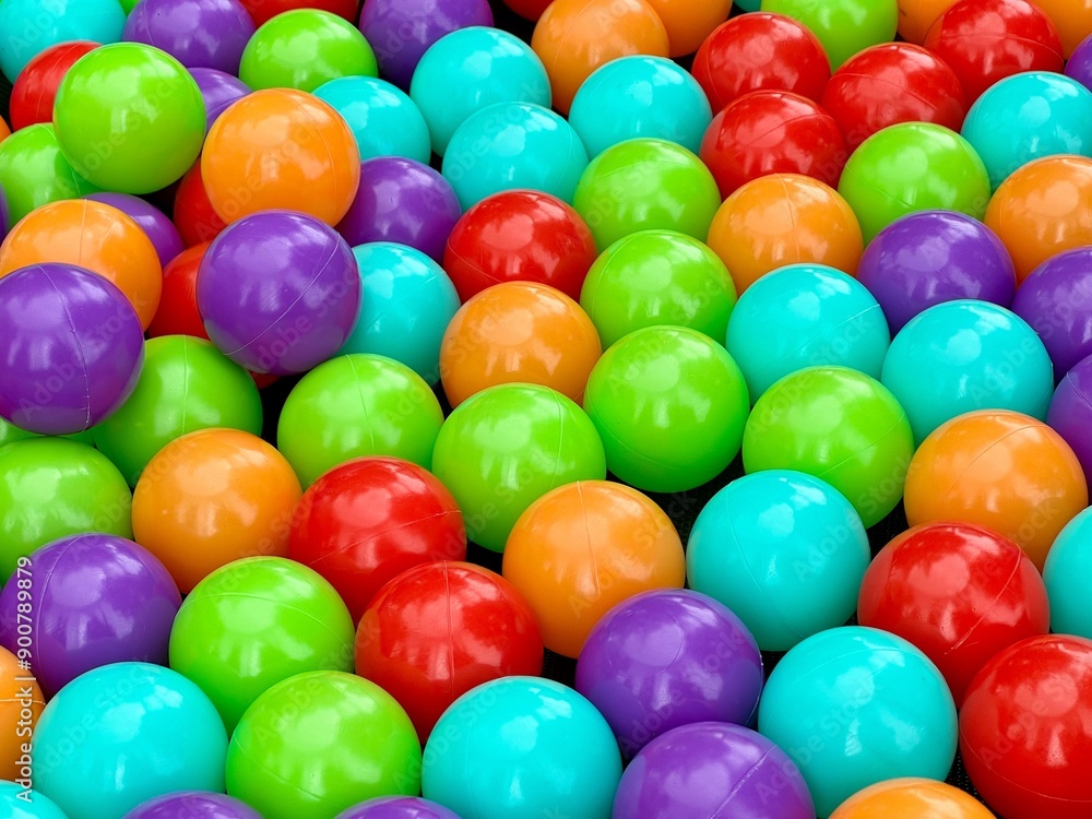 Colourful balls in a ball pool. Close view. Multi-coloured background Colourful balls in a ball pool. Close view. Multi-coloured background