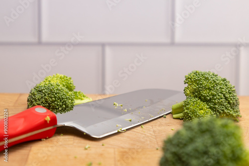 Chopped Broccoli on cutting board with Santoku Knife photo