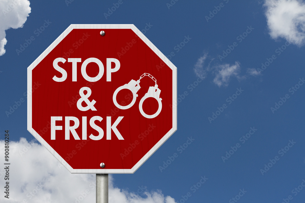 Stop and Frisk message with handcuffs on red street stop sign Stop and Frisk message with handcuffs on red street stop sign