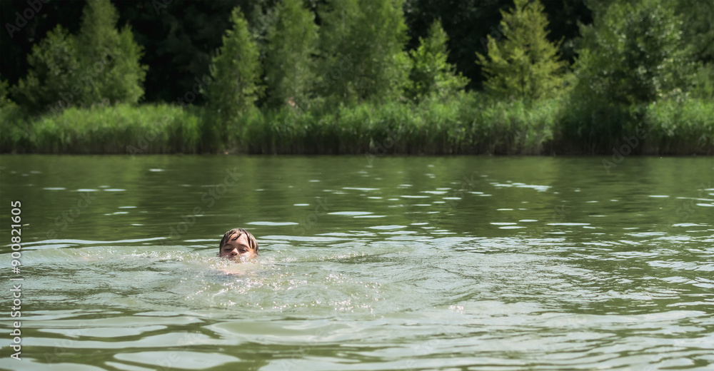 Fototapeta premium Children swim and play in the lake