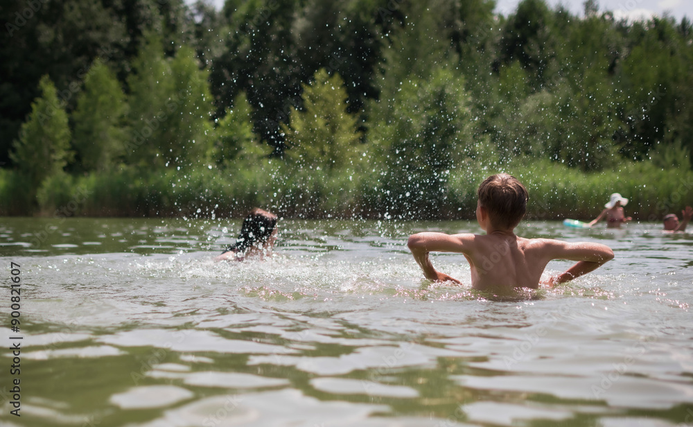 Fototapeta premium Children swim and play in the lake