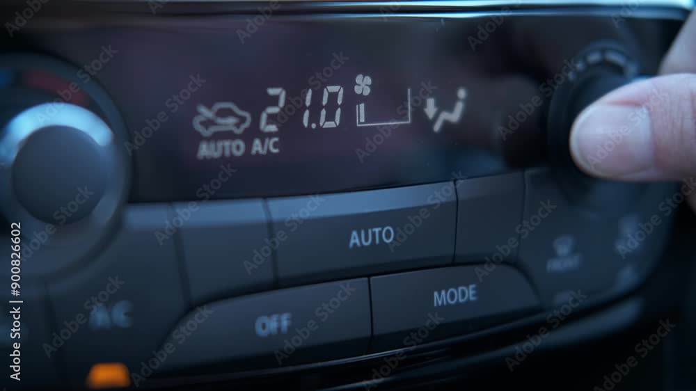 Use automotive air control in car. A view of female use the button of air control on the car panel inside. A concept of cooling the car cabin during hot weather. Use automotive air control in car. A view of female use the button of air control on the car panel inside. A concept of cooling the car cabin during hot weather.