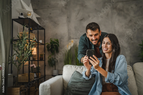 Wife show on cellphone to husband how work cctv surveillance camera photo