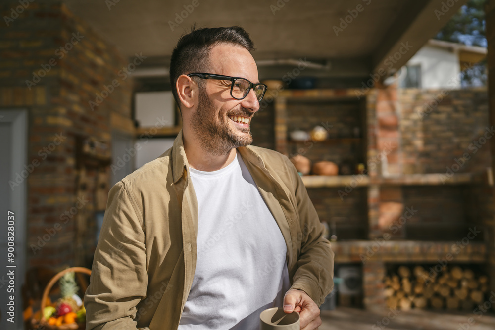Fototapeta premium One man stand at his house in sunny day or morning enjoy cup of coffee