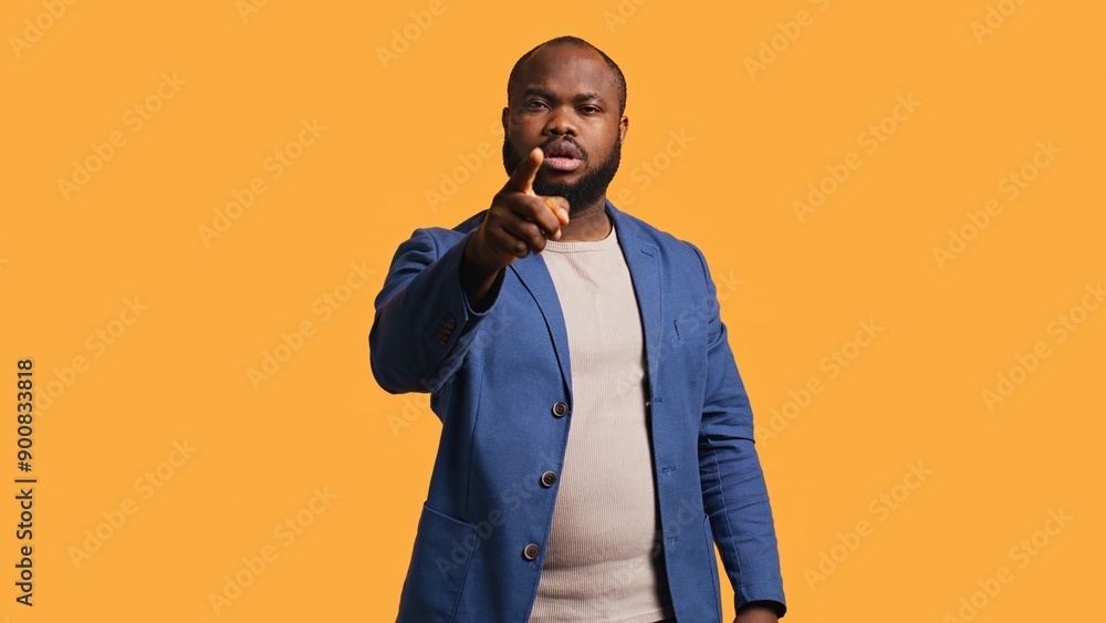 Angry african american man fighting with friend over debacle, isolated over studio background. Rude person in disagreement with mate, swearing and pointing finger, camera B Angry african american man fighting with friend over debacle, isolated over studio background. Rude person in disagreement with mate, swearing and pointing finger, camera B
