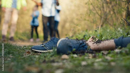 Konstfotografi Search party team finding unrecognizable barefoot dead body in the woods, rescuers calling the police to deal with the mysterious gruesome homicide