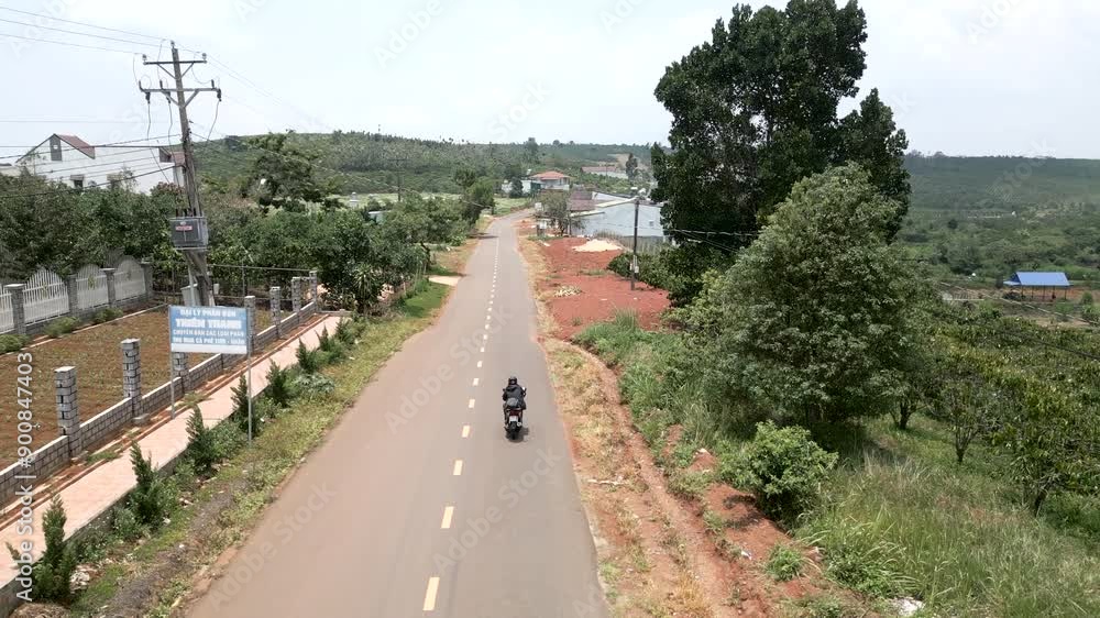 The drone following the motorcycle crashes into a cable crossing the road in Vietnam The drone following the motorcycle crashes into a cable crossing the road in Vietnam