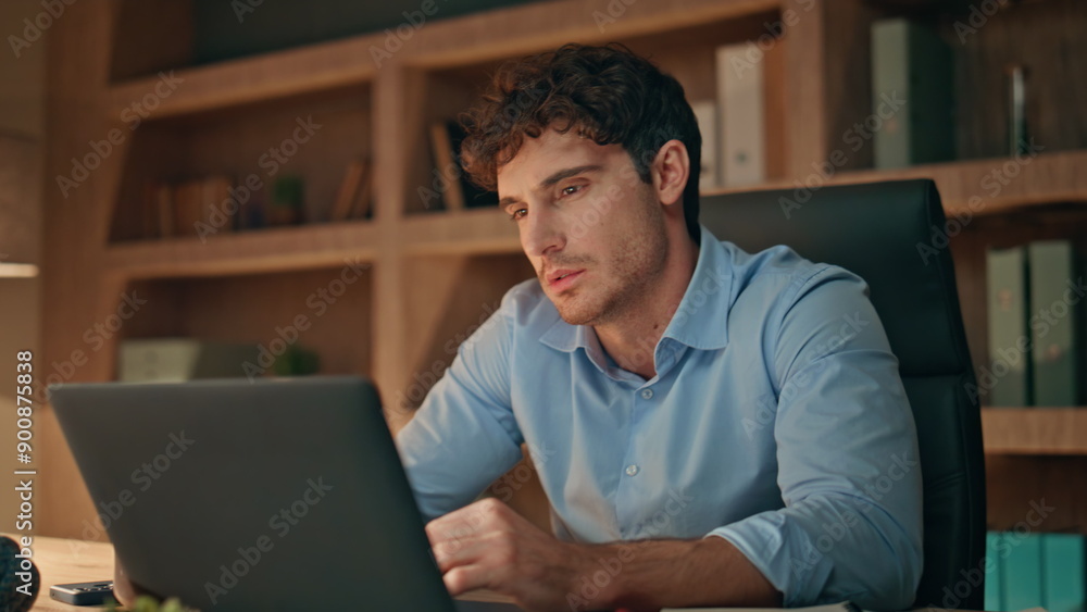 Busy freelancer looking laptop pondering business issue late evening close up. Busy freelancer looking laptop pondering business issue late evening close up.