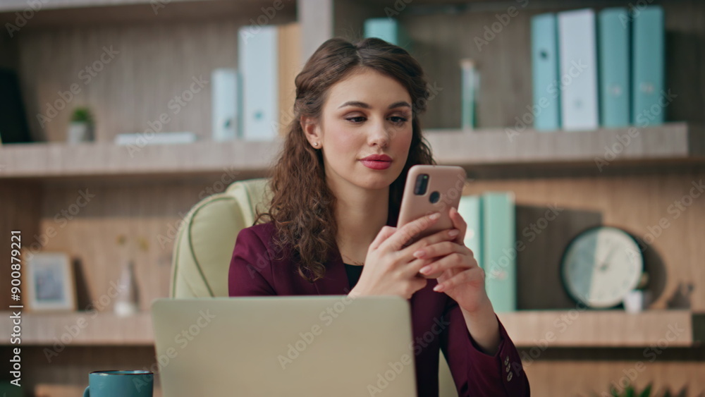 Smiling worker texting cellphone at workplace closeup. Happy businesswoman using Smiling worker texting cellphone at workplace closeup. Happy businesswoman using