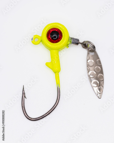 Obraz na plátně Chartreuse fishing jig lure with a fake eye and a silver spoon on white backgrou