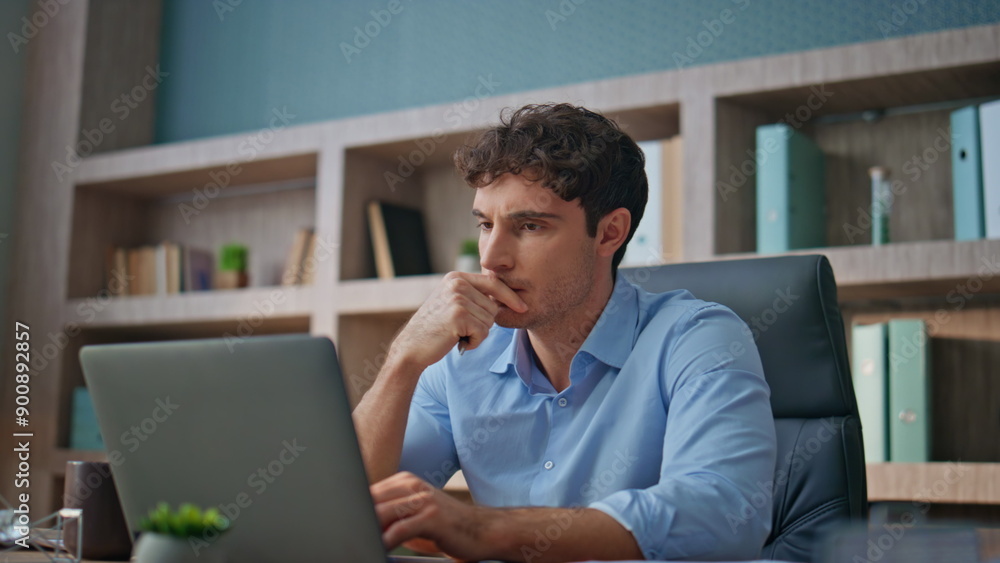 Focused professional thinking problem in office closeup. Young businessman read Focused professional thinking problem in office closeup. Young businessman read