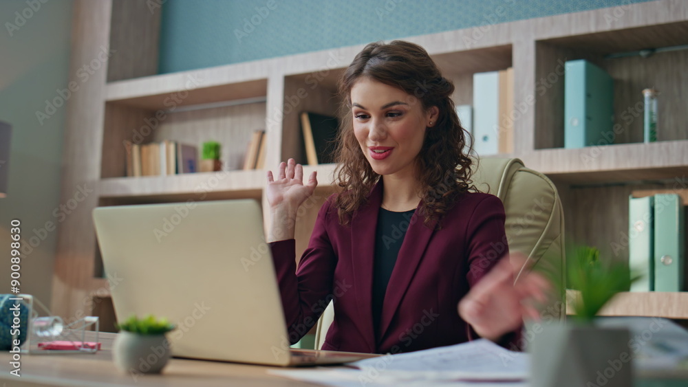 Young businesswoman calling laptop conference in office. Smiling woman greeting Young businesswoman calling laptop conference in office. Smiling woman greeting