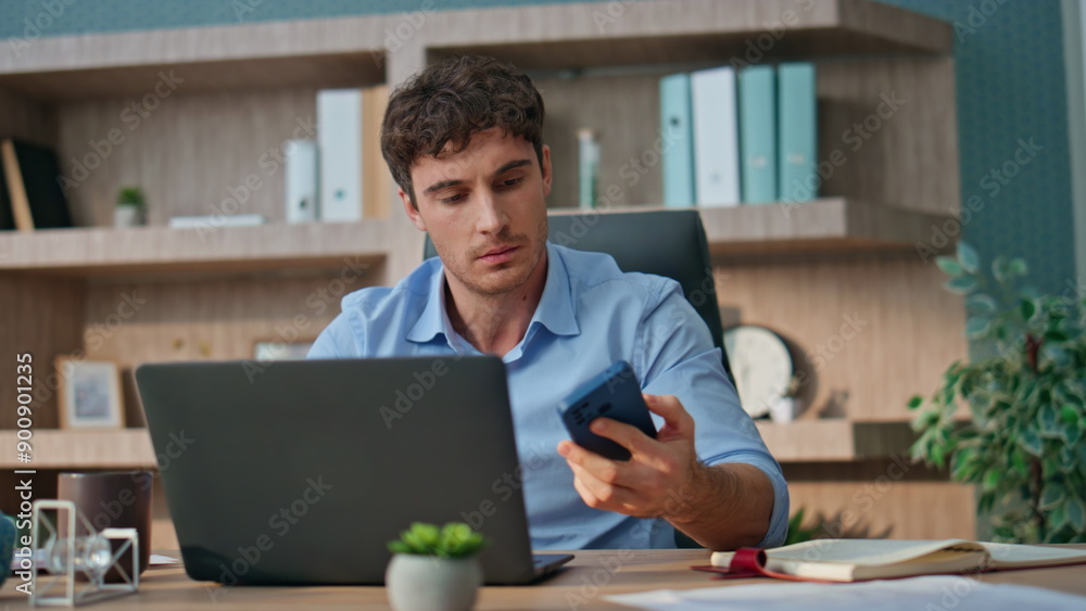 Business worker celebrating message in office. Happy man receiving good news Business worker celebrating message in office. Happy man receiving good news