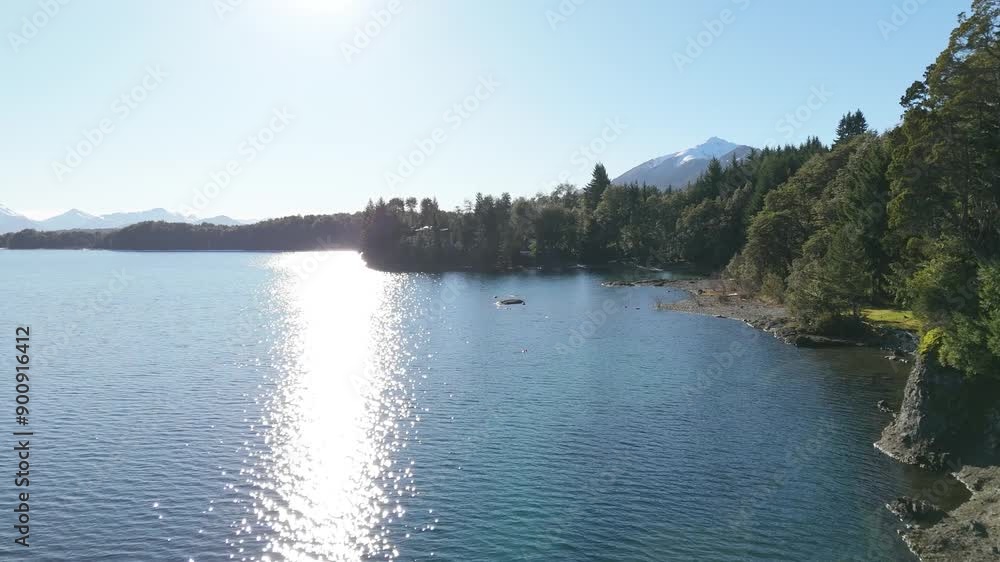 A breathtaking aerial view of a pristine lake surrounded by lush forests and majestic mountains in the background - Puerto Manzano- Villa la Angostura- Patagonia - Argentina A breathtaking aerial view of a pristine lake surrounded by lush forests and majestic mountains in the background - Puerto Manzano- Villa la Angostura- Patagonia - Argentina