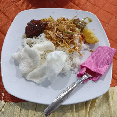 white rice with chicken soy sauce, and noodles with peanut sauce. with crackers photo