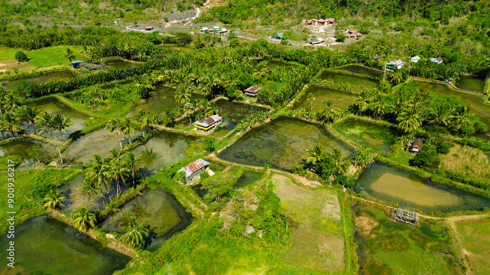 View from the air, Rammang-rammang tourist village with karst mountains and green trees View from the air, Rammang-rammang tourist village with karst mountains and green trees