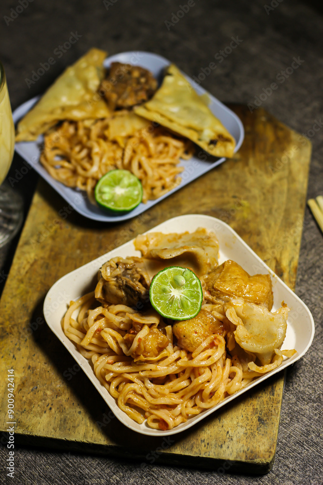 Noodles with dumplings on a dark background. Asian food. Japanese fried dumplings. Chinese udon noodles Noodles with dumplings on a dark background. Asian food. Japanese fried dumplings. Chinese udon noodles