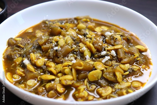 Aluche fatfate or alu wal chi patal bhaji is a traditional, authentic Maharashtrian dish. colocasia leaves and lima beans curry. It has a sweet and sour taste. Valachi aamti. Fadfade. Monsoon recipes. photo