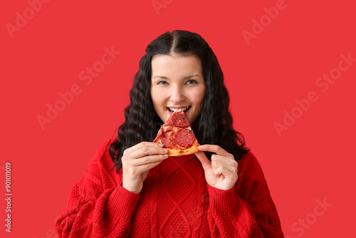 Happy young woman eating ta...