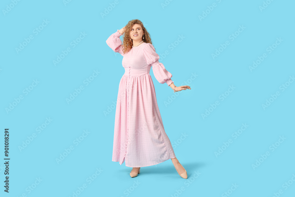 Beautiful young woman in stylish pink dress on blue background Beautiful young woman in stylish pink dress on blue background